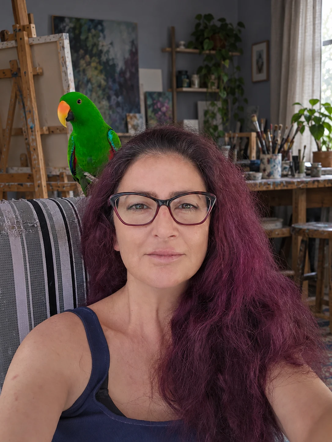 Alla Ostrovsky with a green parrot